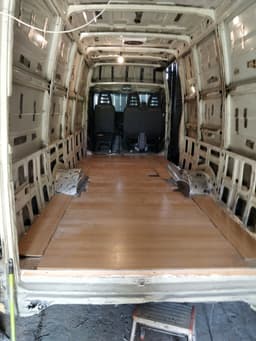 Van inside with temporary wooden floor